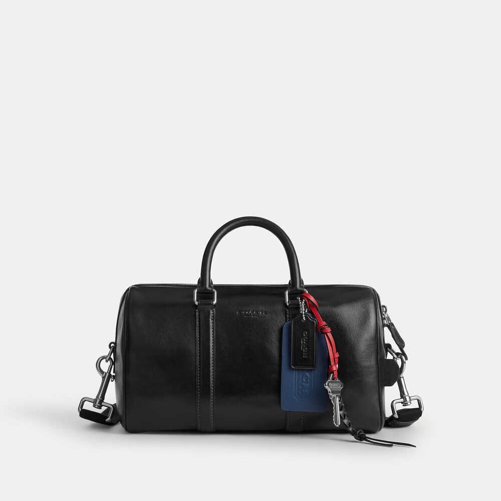 Coach Black Leather Duffel with Red Braided Charm and Blue Tag